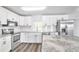 Updated kitchen with white cabinets, granite countertops, and stainless steel appliances at 1508 Fort Duquesna Dr, Sun City Center, FL 33573