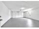 Clean and spacious garage with gray epoxy flooring at 1508 Fort Duquesna Dr, Sun City Center, FL 33573