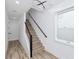 Modern staircase with metal railing and light wood steps at 1308 E Columbus Dr # 2, Tampa, FL 33605