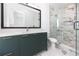 Modern bathroom with dark green vanity and marble shower at 1308 E Columbus Dr # 3, Tampa, FL 33605