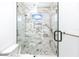 Spa-like shower with marble tile, glass enclosure, and modern fixtures at 1308 E Columbus Dr # 4, Tampa, FL 33605