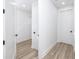 Bright hallway with light wood flooring and access to closets and rooms at 1308 E Columbus Dr # 4, Tampa, FL 33605