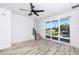Open living area with large windows and ceiling fan at 1308 E Columbus Dr # 4, Tampa, FL 33605