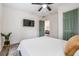 Cozy bedroom with a ceiling fan, and a wall-mounted TV for entertainment at 4304 W Laurel St, Tampa, FL 33607