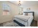 Bedroom featuring natural light, textured walls, and a stylish rug at 4304 W Laurel St, Tampa, FL 33607