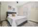 Comfortable bedroom with a blue headboard, patterned rug, and natural light from the window at 4304 W Laurel St, Tampa, FL 33607