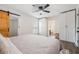 Bright bedroom with white walls, ceiling fan, closet space, and access to an en-suite bathroom at 4304 W Laurel St, Tampa, FL 33607