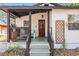 Inviting front porch with wood trim, seating, and decorative lattice, showcasing the home's curb appeal at 4304 W Laurel St, Tampa, FL 33607