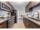 Modern kitchen featuring stainless steel appliances, dark wood cabinets, and sleek countertops for a contemporary feel at 4304 W Laurel St, Tampa, FL 33607