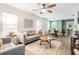 Cozy living room with an open floor plan flowing into the dining area, featuring neutral tones and hardwood floors at 4304 W Laurel St, Tampa, FL 33607