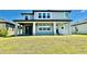 Two-story house with covered patio and grassy yard at 12964 Willow Grove Dr, Riverview, FL 33579