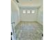 Spacious bedroom with tile flooring and three windows at 12964 Willow Grove Dr, Riverview, FL 33579