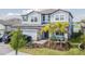 Two-story house with a three-car garage and landscaped front yard at 12964 Willow Grove Dr, Riverview, FL 33579