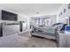 Main bedroom with large TV, dresser, and carpeted floors at 12964 Willow Grove Dr, Riverview, FL 33579