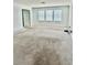 Spacious living room with neutral carpet and multiple windows at 12964 Willow Grove Dr, Riverview, FL 33579
