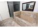 Luxurious bathroom featuring a tiled soaking tub, glass-enclosed shower, and elegant fixtures at 777 N Ashley Dr # 2601, Tampa, FL 33602