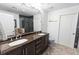 A modern bathroom with double sinks, granite countertops, a large mirror, and a glass-enclosed shower at 777 N Ashley Dr # 2601, Tampa, FL 33602