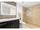 This modern bathroom includes an illuminated mirror, stylish vanity, and glass-enclosed shower at 777 N Ashley Dr # 2601, Tampa, FL 33602