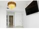 Bright bedroom features a modern chandelier, wall-mounted TV, and large windows with city views at 777 N Ashley Dr # 2601, Tampa, FL 33602