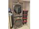 Convenient laundry area with stacked washer and dryer units, plus storage bins for organization at 777 N Ashley Dr # 2601, Tampa, FL 33602
