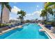 Stunning rooftop pool with lounge chairs, palm trees, and city views, perfect for relaxation at 777 N Ashley Dr # 2601, Tampa, FL 33602