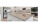 Granite kitchen island with stainless steel appliances at 4939 Eagle Rock Dr, Wimauma, FL 33598
