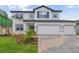 Two-story home with blue shutters and a brick paver driveway at 4939 Eagle Rock Dr, Wimauma, FL 33598