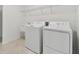 Laundry room with washer, dryer, and utility sink at 4939 Eagle Rock Dr, Wimauma, FL 33598
