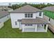 Aerial view of two-story home with covered patio and landscaped yard at 4939 Eagle Rock Dr, Wimauma, FL 33598