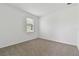 Bright bedroom with neutral carpeting and a window with blinds at 4939 Eagle Rock Dr, Wimauma, FL 33598