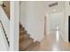 Stairwell with carpeted steps and a view of the foyer at 4939 Eagle Rock Dr, Wimauma, FL 33598