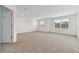 Large main bedroom with carpeted floor and a door to the bathroom at 4939 Eagle Rock Dr, Wimauma, FL 33598