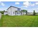 Spacious backyard with a grassy lawn and a view of the house at 4939 Eagle Rock Dr, Wimauma, FL 33598