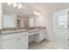 Bathroom with double vanity, granite countertop, and large mirror at 4939 Eagle Rock Dr, Wimauma, FL 33598