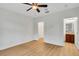 Bright bedroom with ceiling fan, wood-look floors, and access to ensuite bathroom at 111 N Albany Ave # 16, Tampa, FL 33606