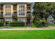 Charming two-story home featuring a front balcony, gated entrance, and lush landscaping at 111 N Albany Ave # 16, Tampa, FL 33606
