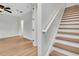 Modern staircase with wood treads, white risers, and a sleek white handrail at 111 N Albany Ave # 16, Tampa, FL 33606