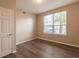 Spacious bedroom with hardwood floors and a window at 5601 Rosehill Rd # 102, Sarasota, FL 34233