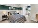 bedroom with a striped comforter, cool artwork, and a desk overlooking a window at 814 Flash Dr, Clearwater, FL 33765