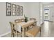 Bright dining area with natural wood table and seating with views of the entryway and backyard at 814 Flash Dr, Clearwater, FL 33765