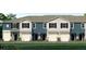 Charming new construction townhomes feature a modern design with attached garages and black shutters at 814 Flash Dr, Clearwater, FL 33765