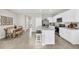 Well-designed kitchen with a breakfast bar island connecting to the dining area and stainless steel appliances at 814 Flash Dr, Clearwater, FL 33765