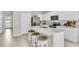 The bright kitchen features a breakfast bar with white countertop and stainless steel appliances at 814 Flash Dr, Clearwater, FL 33765