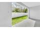 Covered patio showcasing a well-maintained backyard with a white fence and green lawn at 814 Flash Dr, Clearwater, FL 33765