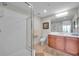The bathroom offers a modern glass-enclosed shower, vanity with drawers, and large mirror, making it luxurious and practical at 3257 Mangrove Point Dr, Ruskin, FL 33570