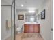 This bathroom offers a vanity with cabinetry, glass-enclosed shower, toilet and a large mirror at 3257 Mangrove Point Dr, Ruskin, FL 33570
