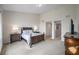 The bedroom provides ample space and a refined, classic design with side tables, lamps, and an en suite at 3257 Mangrove Point Dr, Ruskin, FL 33570