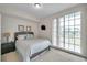 Comfortable bedroom with a queen bed and sliding glass doors to a balcony at 3257 Mangrove Point Dr, Ruskin, FL 33570