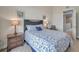 A charming bedroom is decorated with beach-themed artwork, complemented by bedside lamps, a chair, and a view into the home at 3257 Mangrove Point Dr, Ruskin, FL 33570