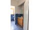 Bathroom with blue tile, wood vanity, and updated fixtures at 16308 Rock Lake Dr, Odessa, FL 33556